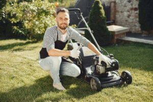 An image of a person doing lawn mower maintenance.