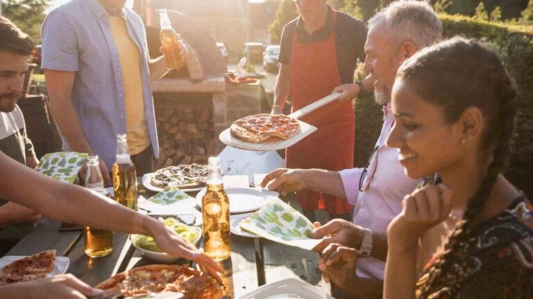 An image of people eating pizza for an article about growing a pizza garden.