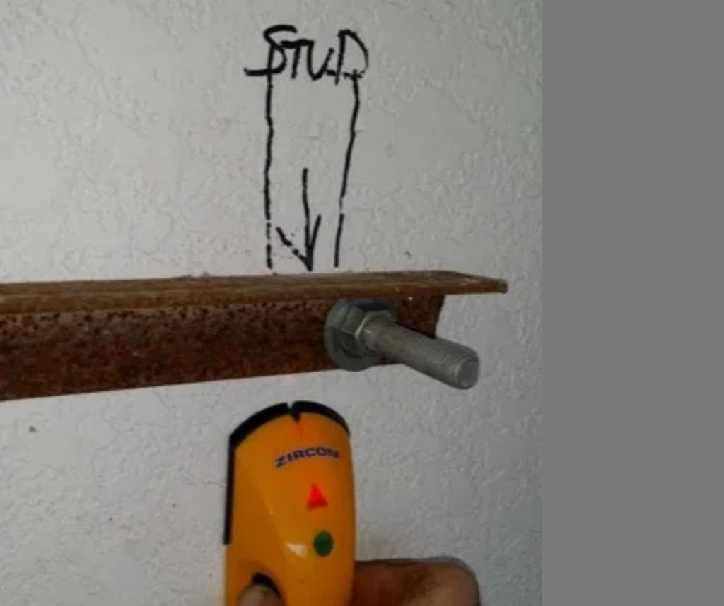 Inside the wall, a 6' angle is drilled to match bolt penetrations and tightened.