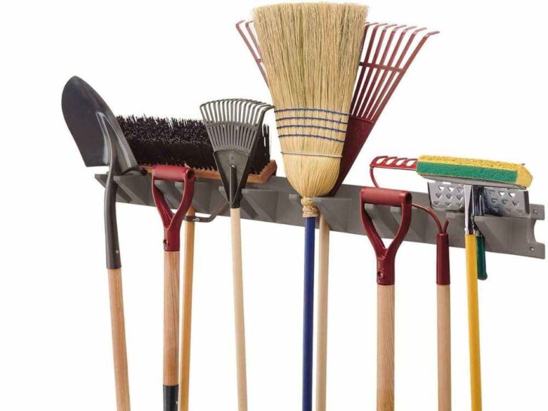 An image of a wall tool rack for an article about yard tool storage ideas.