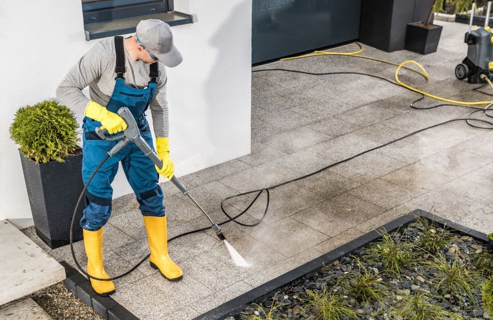 An image of a person using a power washer for an article about power washer black friday deals.