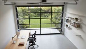 A modern garage-to-office conversion featuring a clear glass garage door.