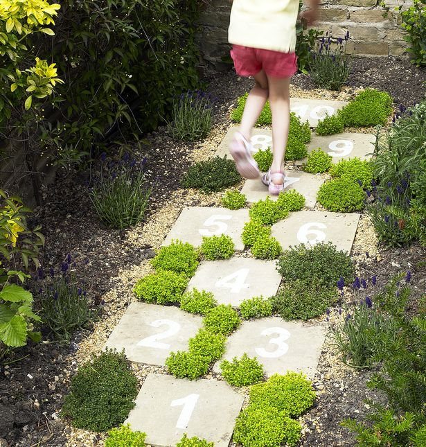 Even this simple path of concrete pavers can be made beautiful when planted out carefully.