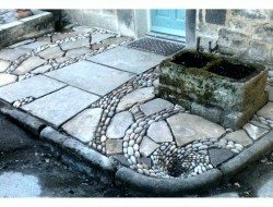 'The patio that flows down the drain' Yorkshire stone flagstones, cobbles finishing with a pebble mosaic whirlpool working drain