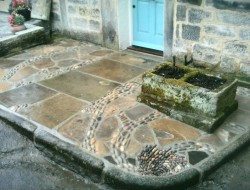 'The patio that flows down the drain' Yorkshire stone flagstones, cobbles finishing with a pebble mosaic whirlpool working drain