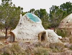 This free-form building appears to be made from mortar and stone. I can't help but think what an amazing cubby it would make for kids - play by day... sleep out at night. Love it or hate it, you must admire the imagination behind the idea :)