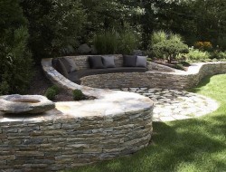 We haven’t given you any dry stone wall ideas for ages.   Here's one we think is worth sharing. It’s a great example of a retaining wall that does NOT interfere with the natural site drainage, and has a seat and cushions too!  Love it or hate it? Let us know what you think in the comments section.