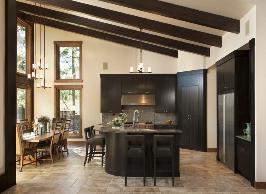 Dark wood cabinetry matches the angled timber in this kitchen