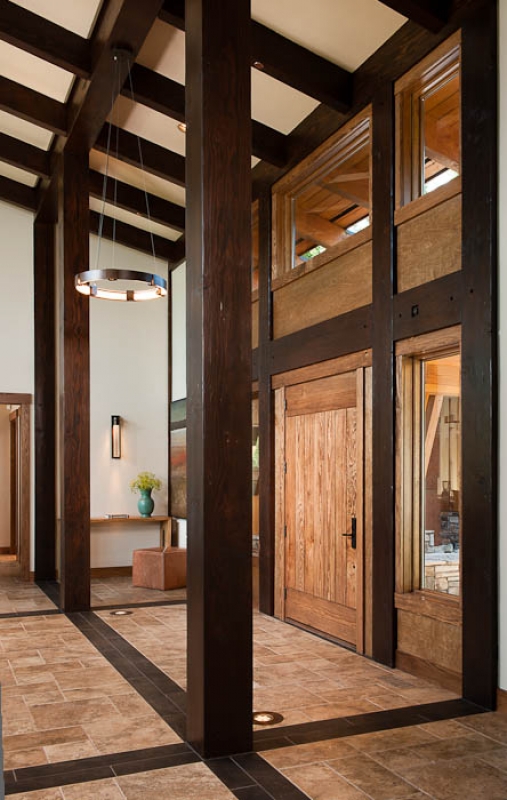 The length of this Washington home's interior entry is framed in dark posts and beams