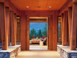 Warm timbers line the extended portico that leads guests to the home's entry