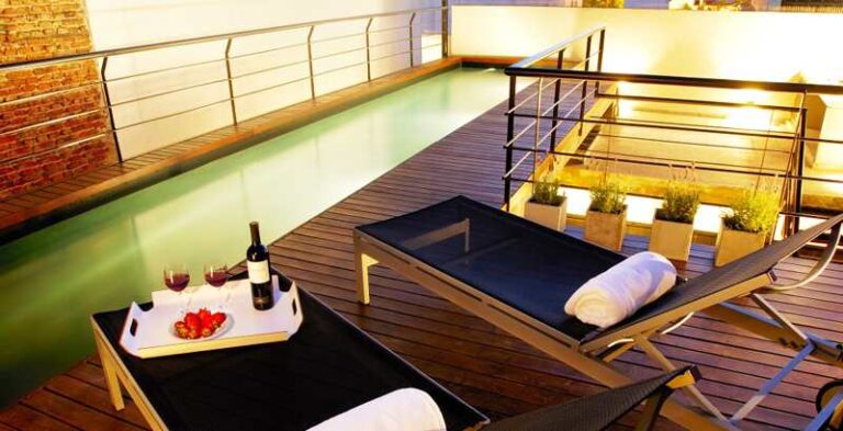A long, narrow pool installed in the terrace of a small house.