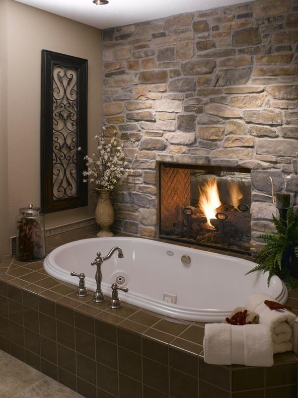 We previously featured a bathroom with a fireplace. Would this be great on cold night or what???