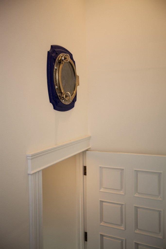 The porthole looks out over the entry stairs, making some interesting wall art as well.