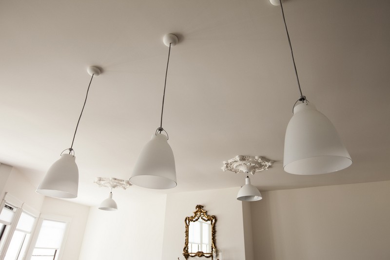 Keeping the original details of the house and bringing in a modern flair, makes the interior spaces fun and interesting. The medallions on the ceiling were kept, and new light fixtures brought in.