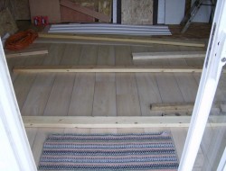 How To Build A DIY Pallet Shed - Putting linoleum on the floor