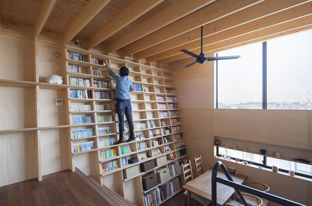 The bookshelf spans both levels of the house.