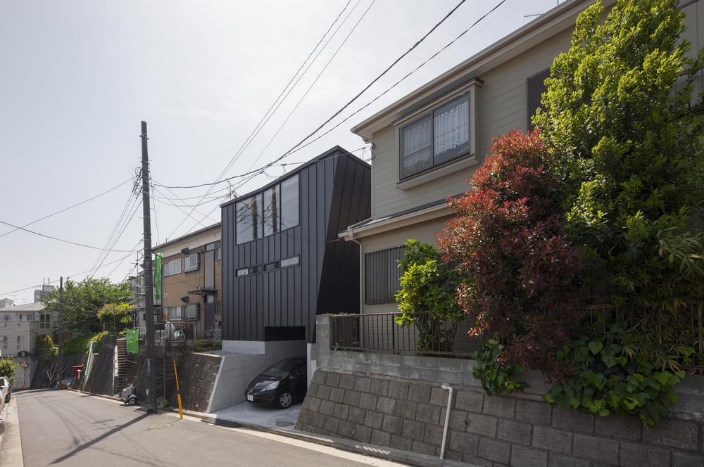 Bookshelf House is a typical Japanese house in a typical neighborhood with atypical interiors.