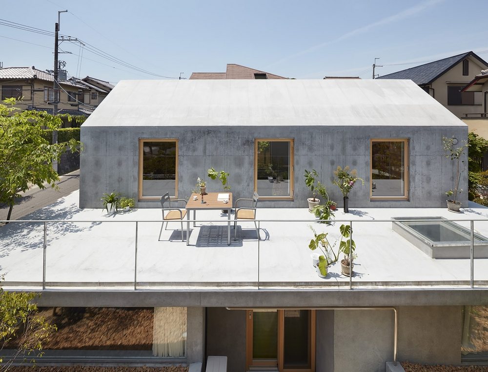 The upper part of the house sits on a concrete slab, making it look like it's floating.