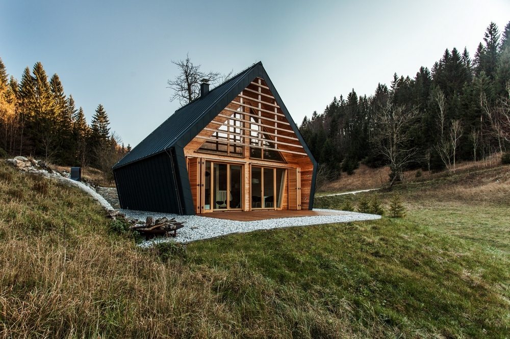 A striking hexagon-shaped house in the middle of the forest.