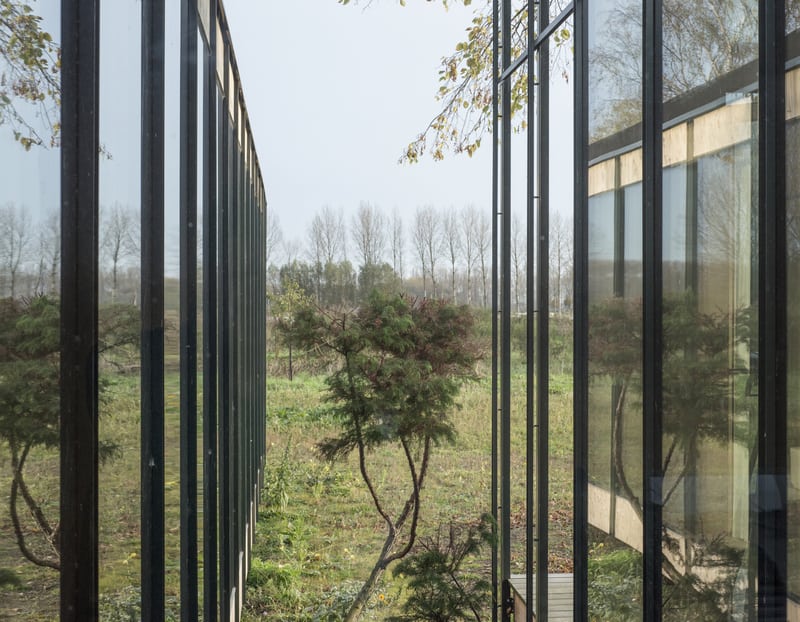 The house has its back on the street, facing agricultural land.