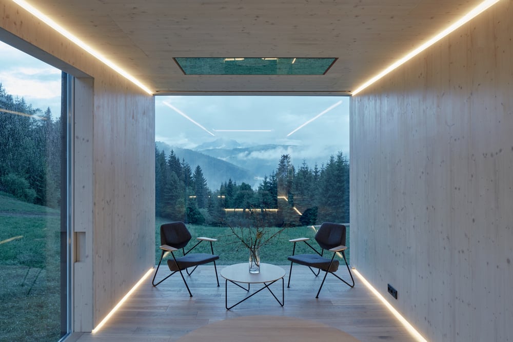 Large windows and openings provide stunning views of the surrounding landscape.