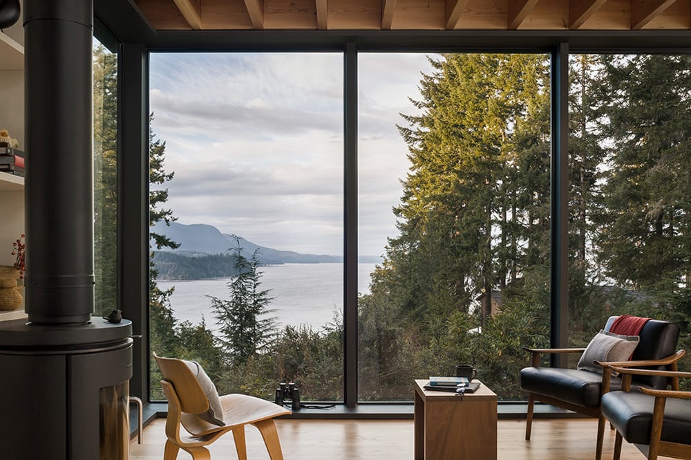 The living areas of the Little House offer stunning views of the tall trees and glistening waters.