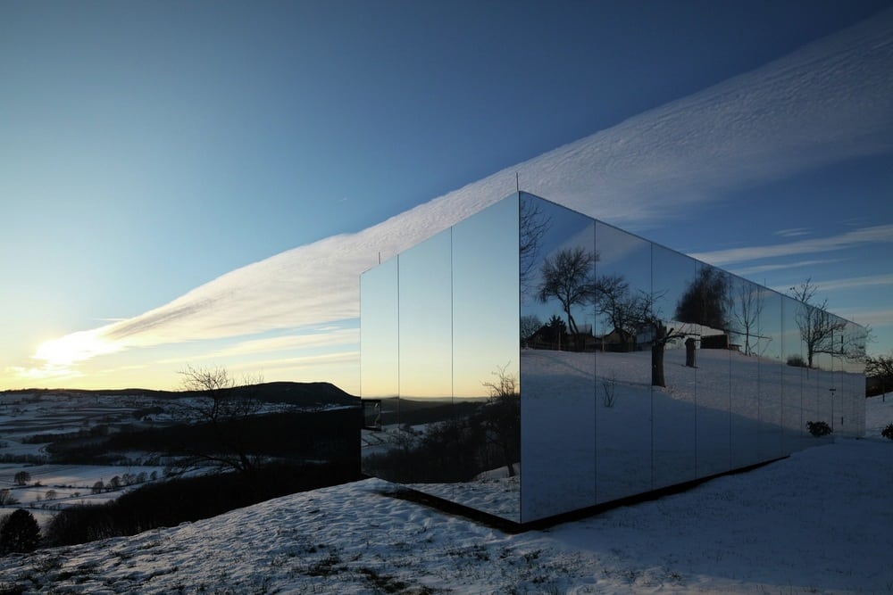 The reflective facade of Casa Invisible allows it to blend seamlessly well with its environment.