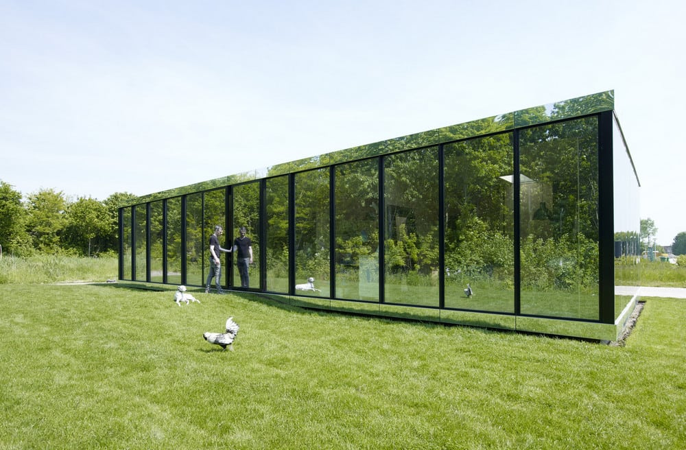 The Mirror House looks invisible as it reflects the surrounding landscape.