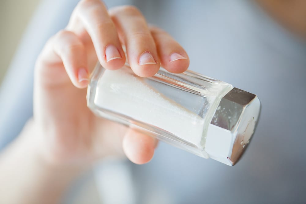 Add about a teaspoon of uncooked rice to your salt shaker to soak up that extra moisture. 