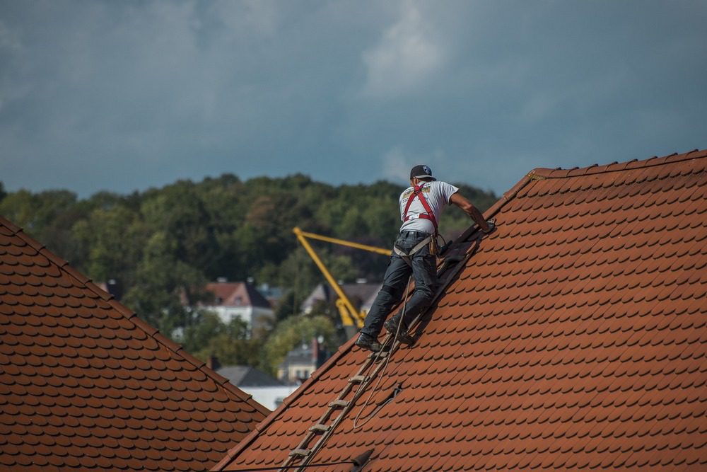 A roof repair involves a lot of noisy construction work and many workers.