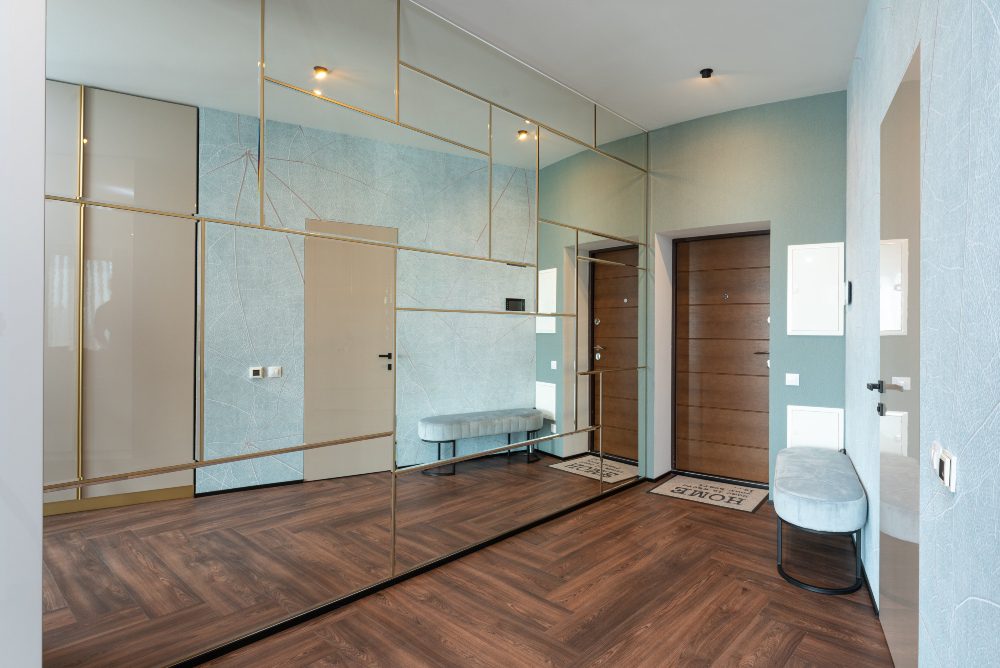 An image of an apartment mud room entry with wood flooring. 