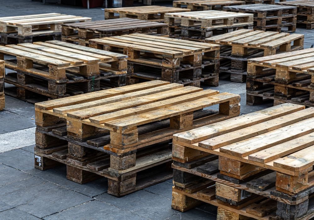 An image of pallets stacked outside. 