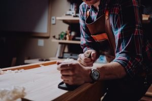 man working in his small woodworking shop