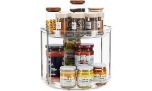 An image of a transparent lazy susan spice rack full of spices and ingredients.