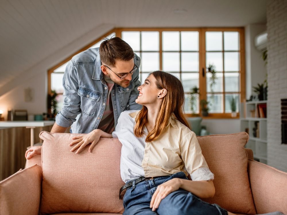 An image of a Gen Z couple on a couch. 