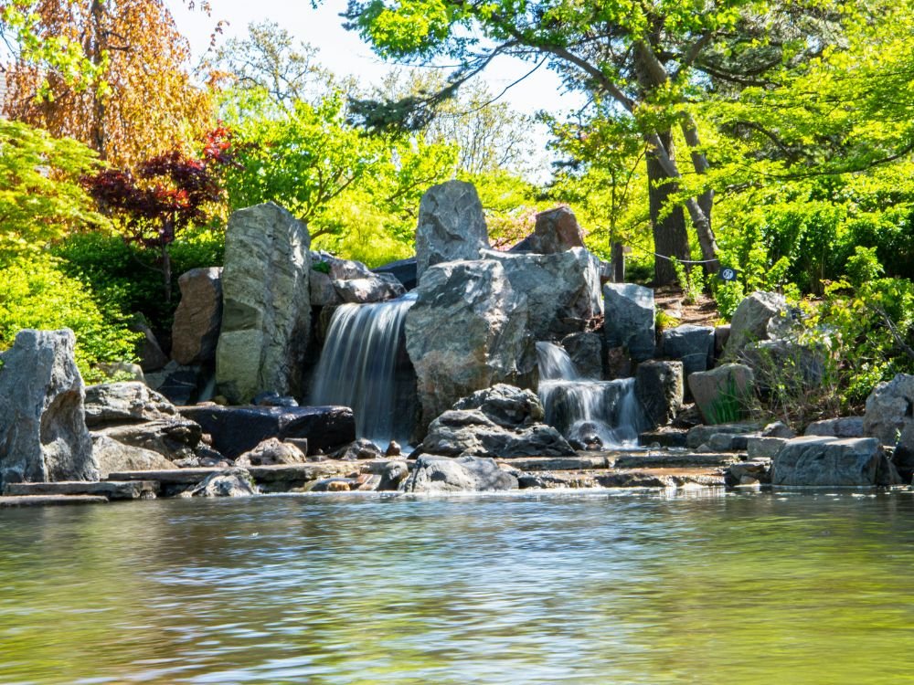 An image of a rock formation waterfall in a forest. 