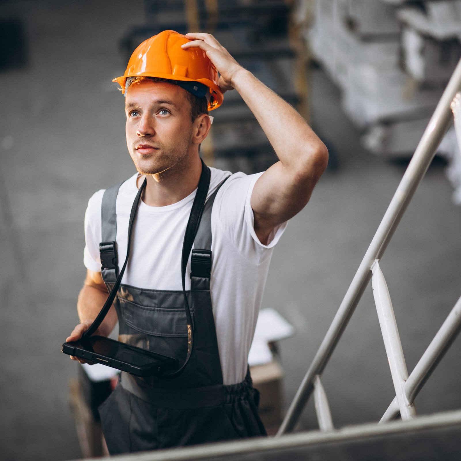 An image of a contract worker with an orange helmet. 