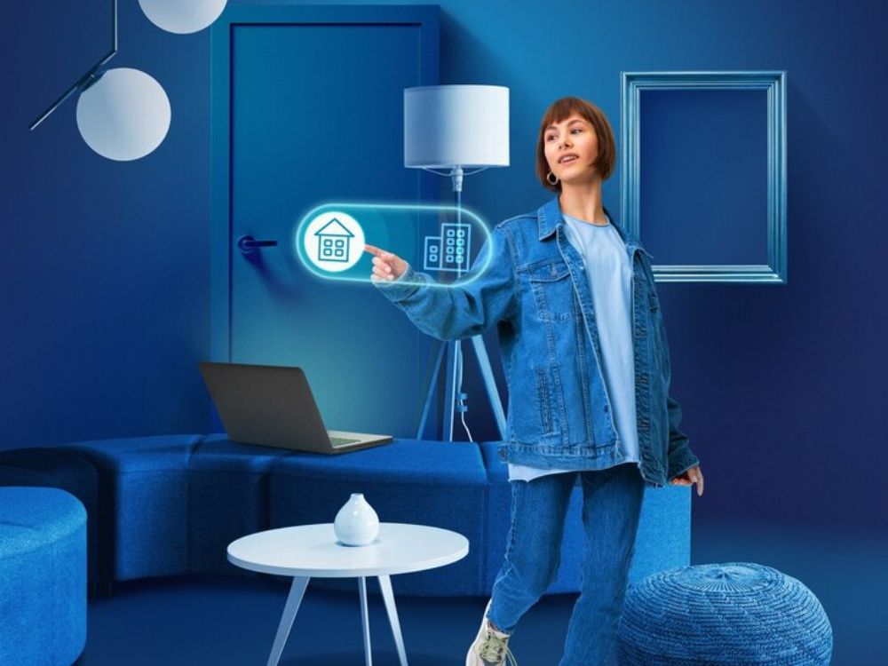 An image of a home owner pushing a holographic button. 