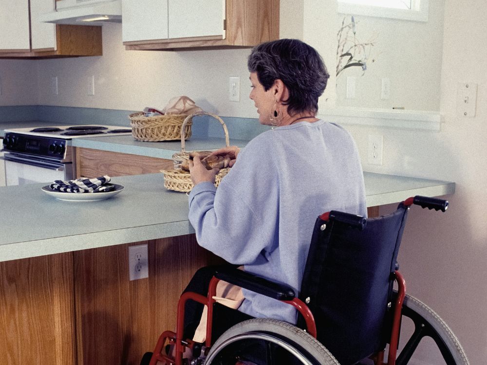 An image of a woman in a wheelchair. 