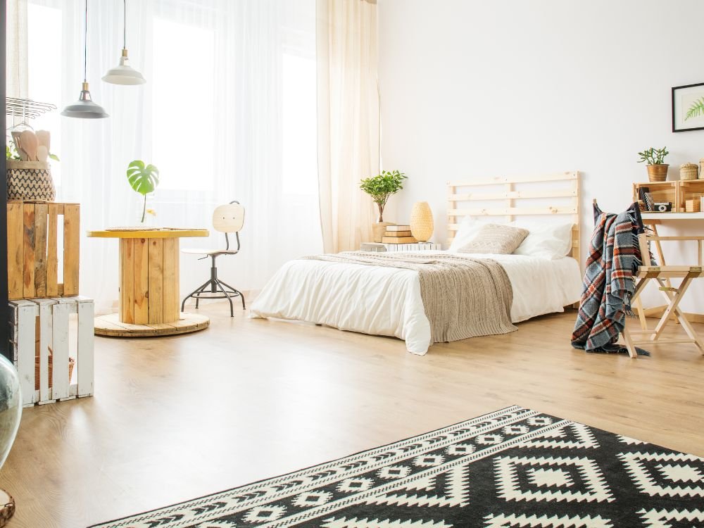 An image of a studio apartment layout with pallet furniture.