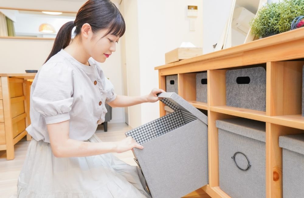 An image of a woman opening an organization box.
