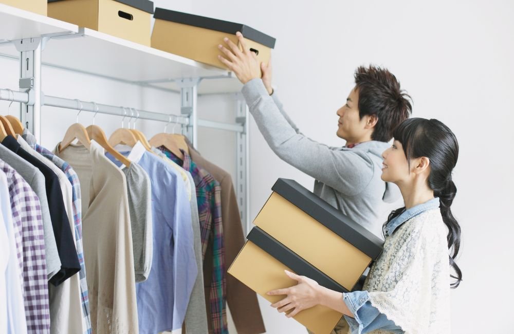 An image of a couple doing seasonal home organization.