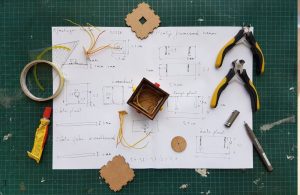An image of a blueprint and tools.