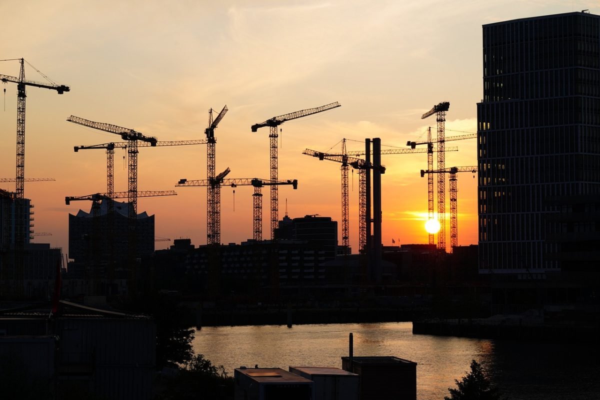A skyline of construction cranes