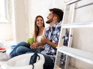 A young couple preparing their home for sale.