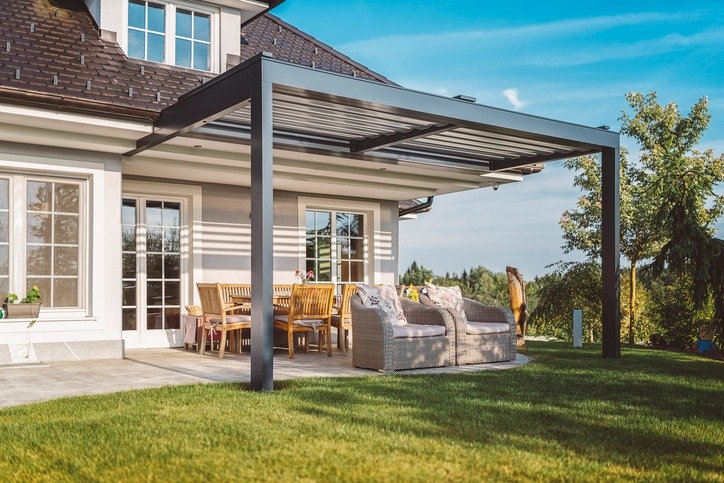 Smooth concrete patio under a modern pergola, showcasing a minimalist finish for contemporary outdoor living.